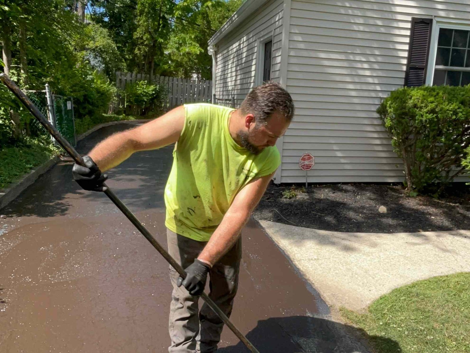 Man applying sealant to a driveway