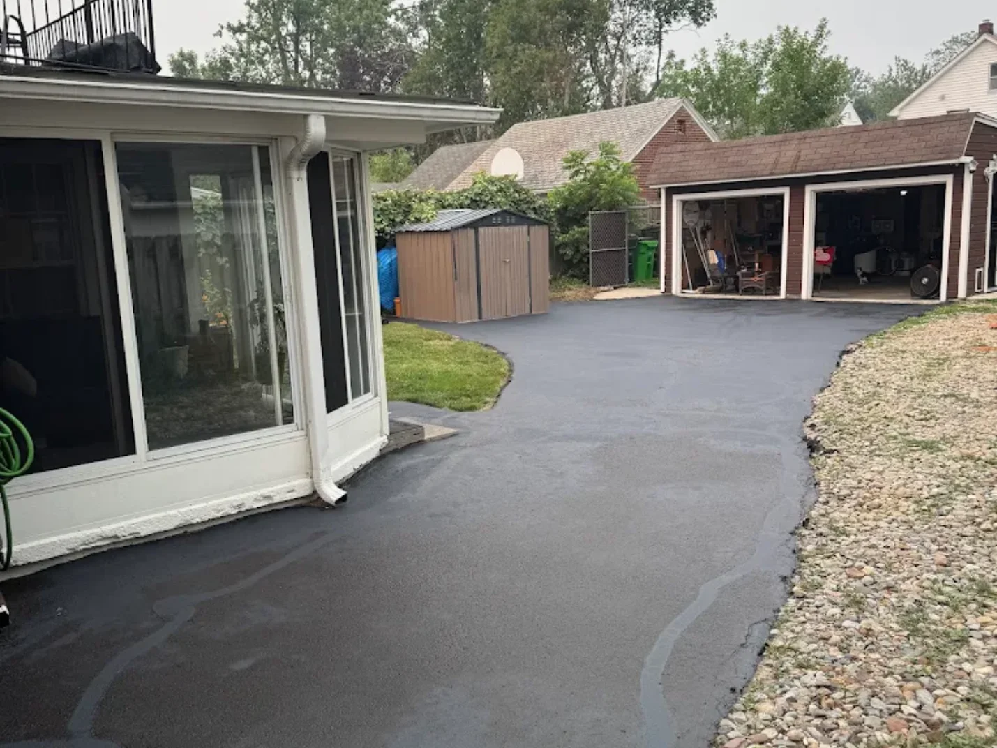 Technician applying asphalt seal coating